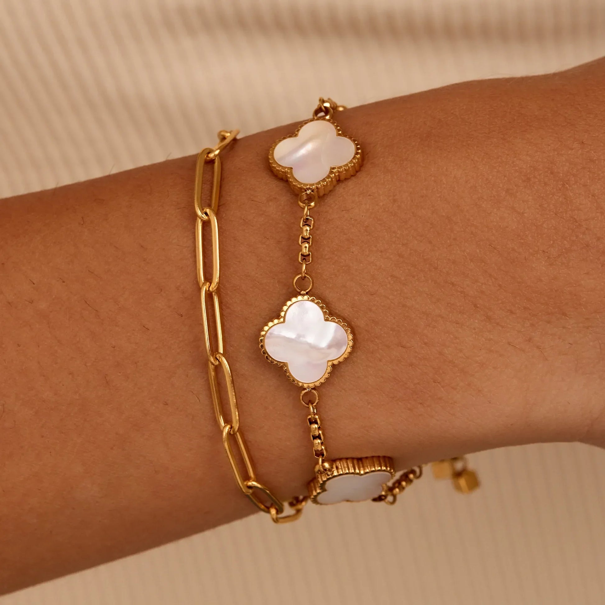 Gold pearl clover bracelet worn on wrist — Olivia Jewelry
