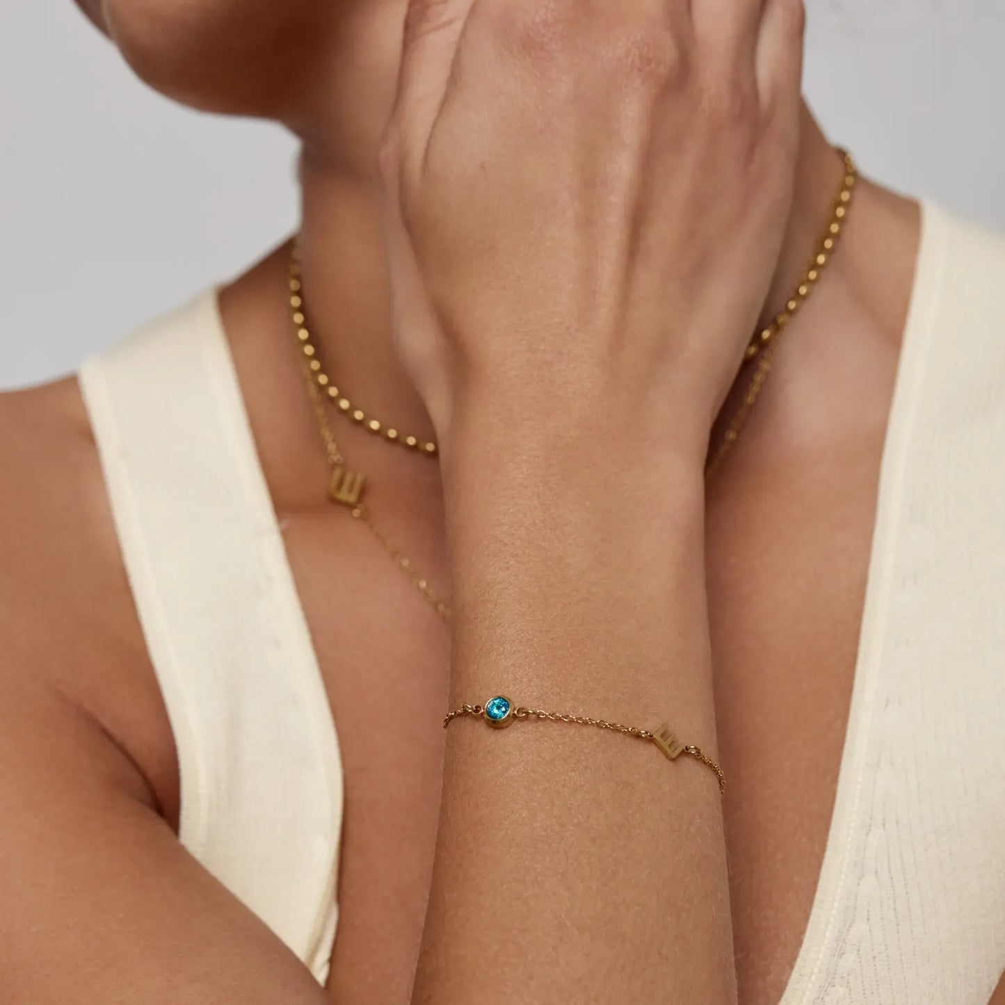 Initial birthstone bracelet lifestyle shot — Olivia Jewelry