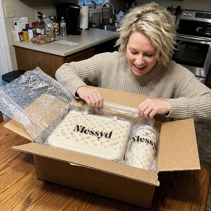 Cream tote and matching tumbler unboxed at a kitchen table