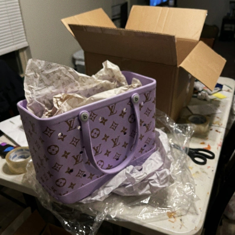 Lilac perforated tote on a white table with tissue paper