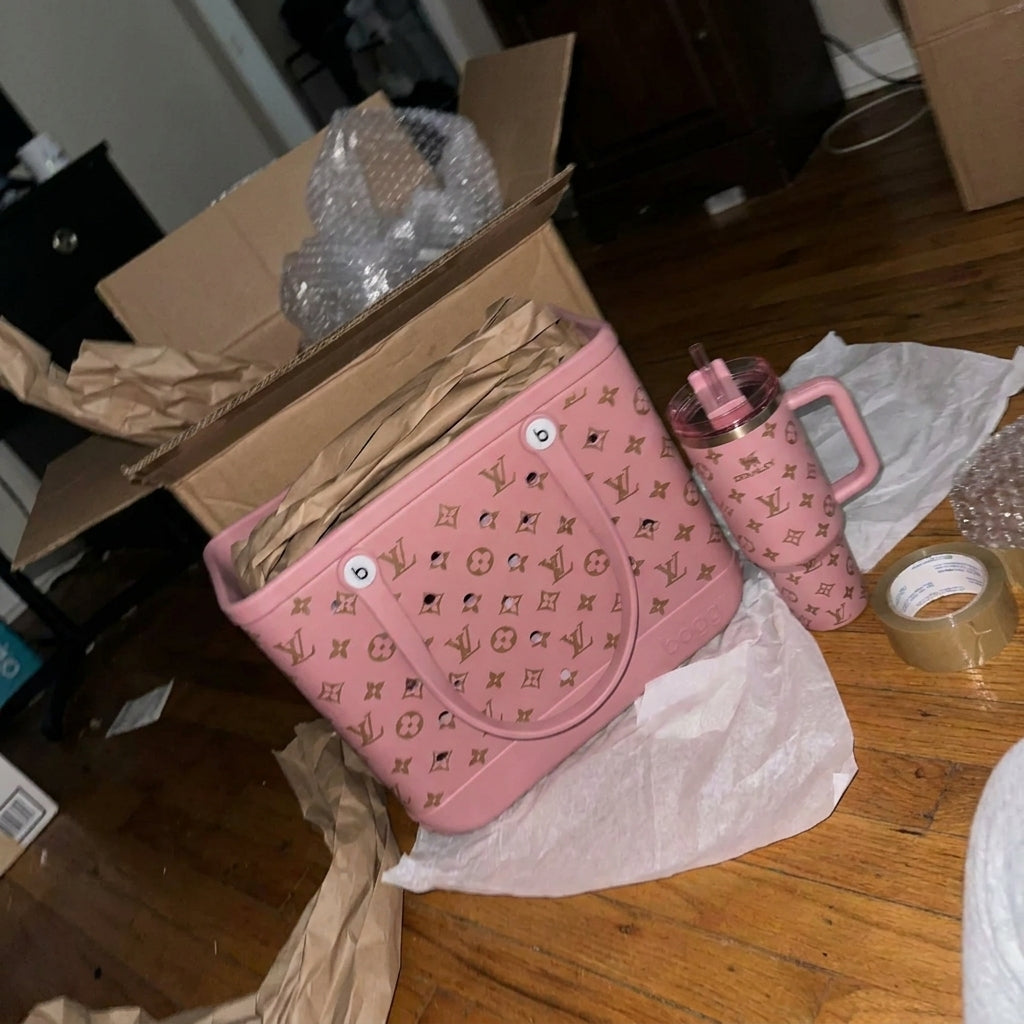 Pink tote and matching tumbler on packing paper