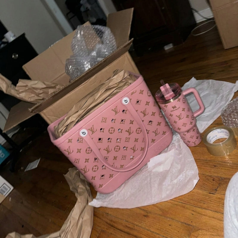 Pink tote and matching tumbler on packing paper