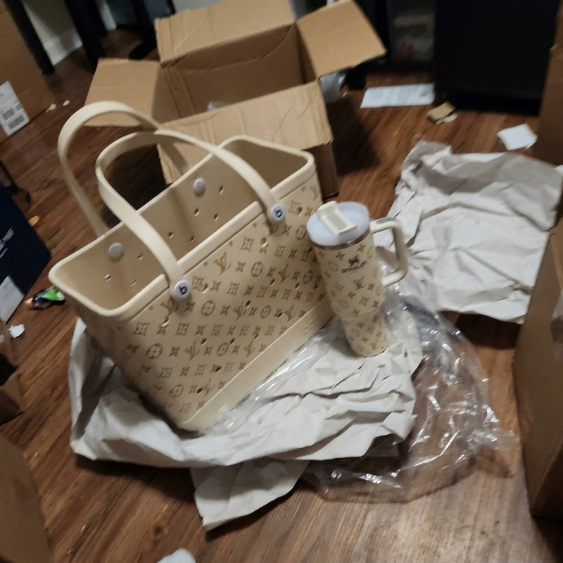 Cream tote and matching tumbler beside an empty shipping box