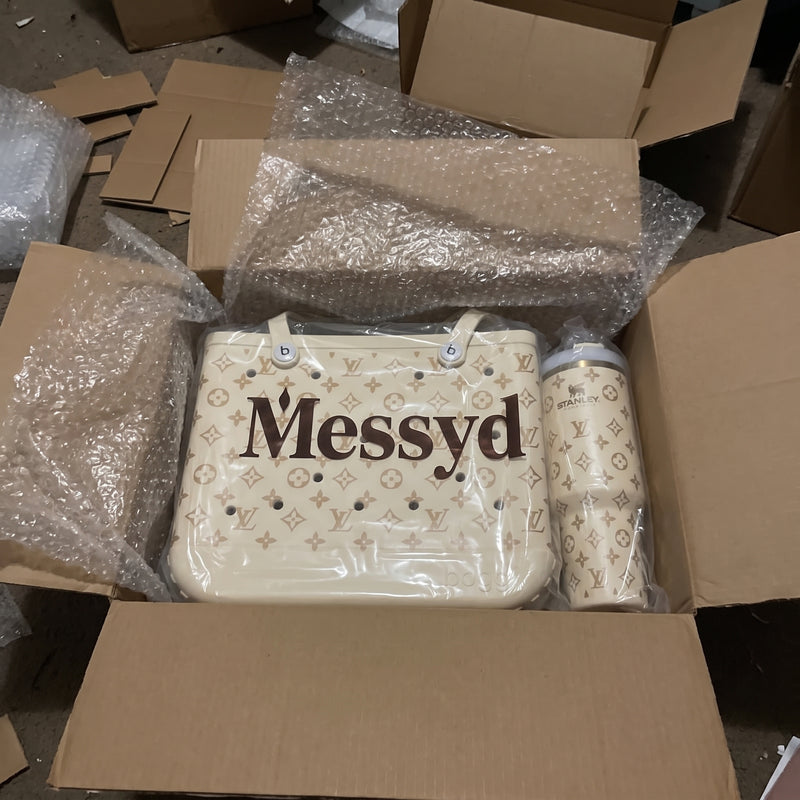 Cream Messyd tote and matching tumbler in a box with bubble wrap