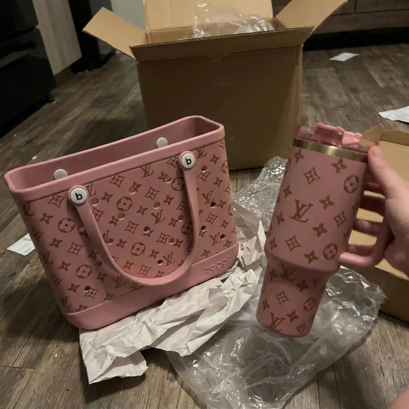 Pink tote next to a matching tumbler held after unboxing